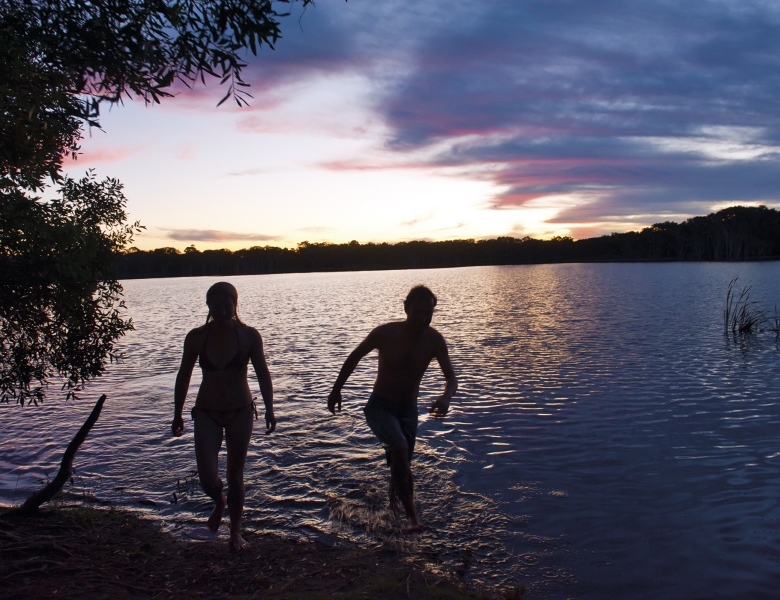 Couple getting out of the water at Lake Ainsworth