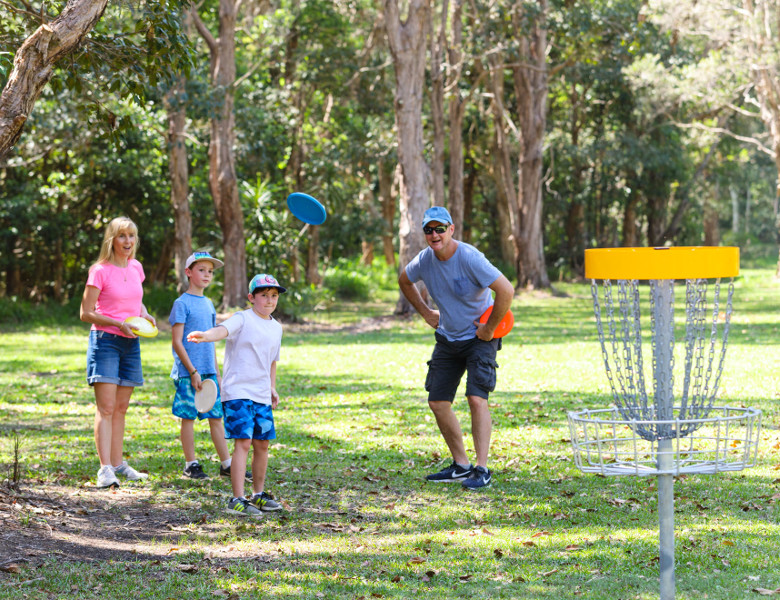 Family playing disc golf